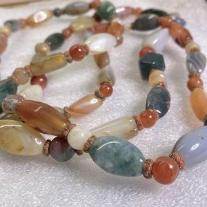 Large hanging stone necklace with green, gray, white, orange  accents
